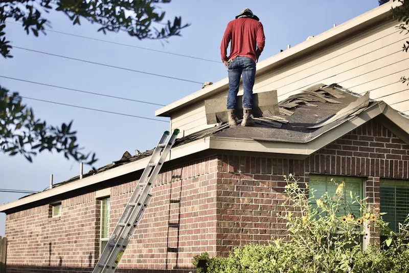 Professional roofer working on a residential roof in Stotts Crossroads